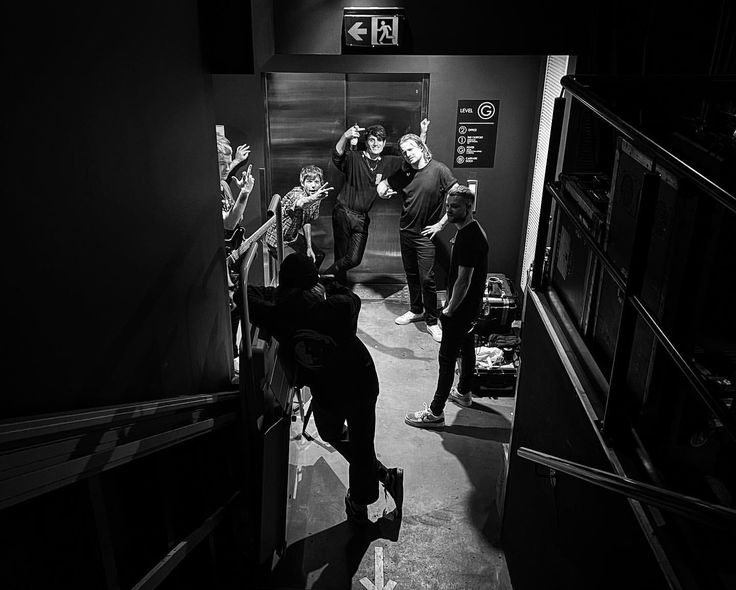 black and white photograph of people standing in an elevator