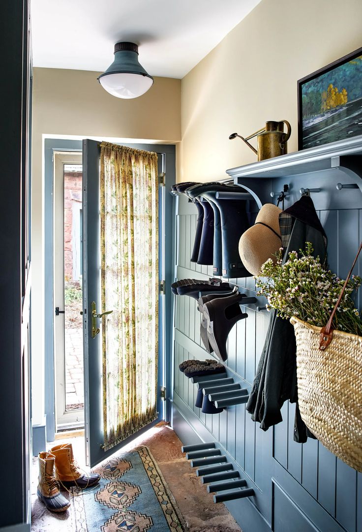 an open door leading to a hallway with clothes hanging on the rack and other items