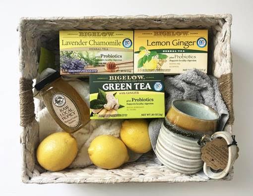 a basket filled with lemons, tea and other items