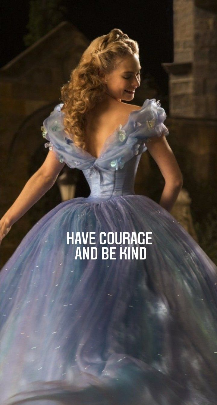 a woman in a blue dress with the words have courage and be kind