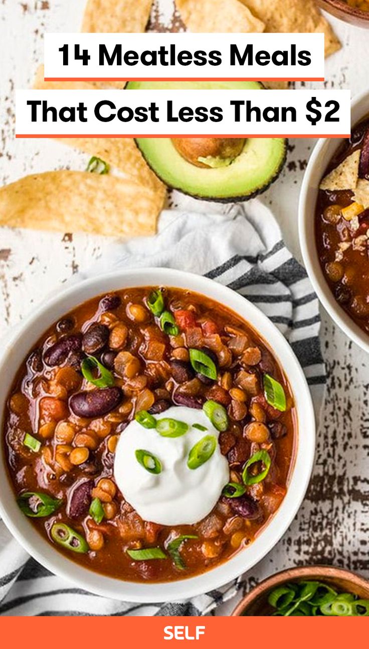 two bowls filled with chili and beans next to tortilla chips, avocado