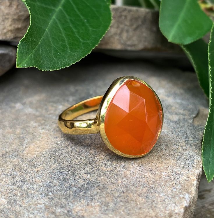 "14k Yellow Gold Sterling Silver Carnelian Hammered Ring Size 7 Up for offer is a beautiful 14k yellow gold over solid sterling silver, checker faceted carnelian, hammered band ring. Ring is marked \"925\". Measurements Ring Size: 7 Band Width: 2.7mm Carnelian: 16mm x 13mm x 5.5mm Weight: 4 g Materials -14k Yellow Gold -Sterling Silver -Carnelian Condition: New; please inspect pictures for overall condition. This item comes from a clean, smoke free household. Item will ship within 24-48 hours of Carnelian Gemstone Rings For Anniversary, Orange Ruby Ring For Anniversary, Gold Carnelian Ring For Anniversary, Amber Carnelian Rings For Anniversary, Gold Carnelian Anniversary Rings, Anniversary Orange Ruby Ring, Heirloom Style Orange Ring For Gift, Gold Rings With Carnelian Gemstone, Heirloom Orange Ring As Gift