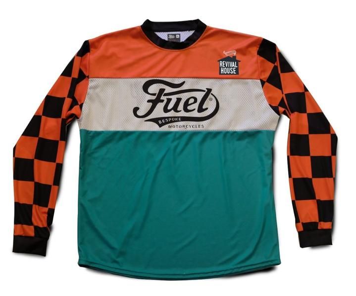 an orange and green jersey with the word fuel on it's chest, sitting in front of a white background