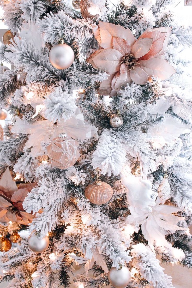 a white christmas tree with ornaments and lights