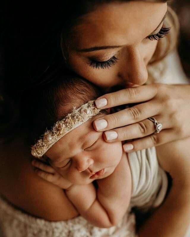 a woman holding a baby in her arms