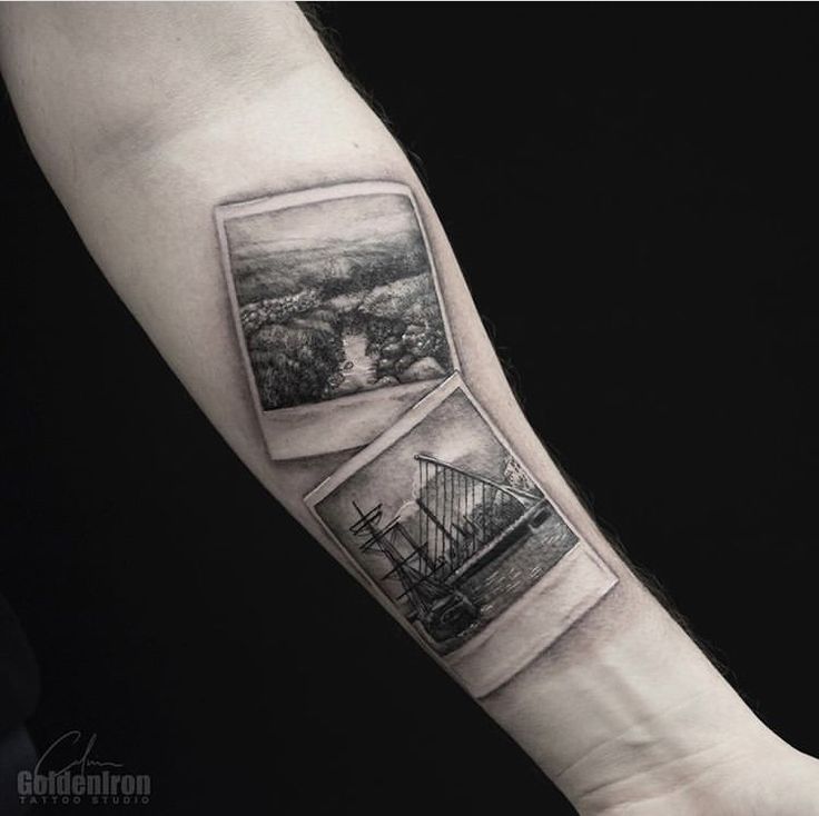 a black and white photo on the arm of a man with a bridge in it