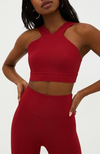 A textured fabric and high neck energize this cropped tank that will power you through your next sweat session or brighten your morning walk. 13" length (size Medium) V-neck Lined 79% polyester, 21% spandex Machine wash, tumble dry Imported Red Seamless Sleeveless Sports Bra, Seamless Red Sleeveless Sports Bra, Seamless Red Sports Bra, Halter Neck Yoga Tops With Seamless Construction, Halter Neck Tops With Seamless Construction For Yoga, Seamless Halter Neck Yoga Tops, Seamless Halter Neck Tops For Yoga, High Neck Athleisure Activewear For Gym, Red High Stretch Sleeveless Sports Bra