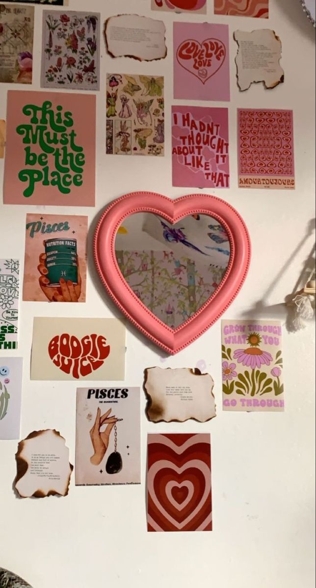 a white table topped with lots of magnets and paper cut out in the shape of a heart