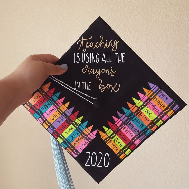 a hand holding a graduation cap that says teaching is using all the crayons in the book