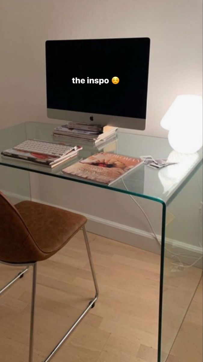 a glass desk with a computer on it and the words the imppo above it