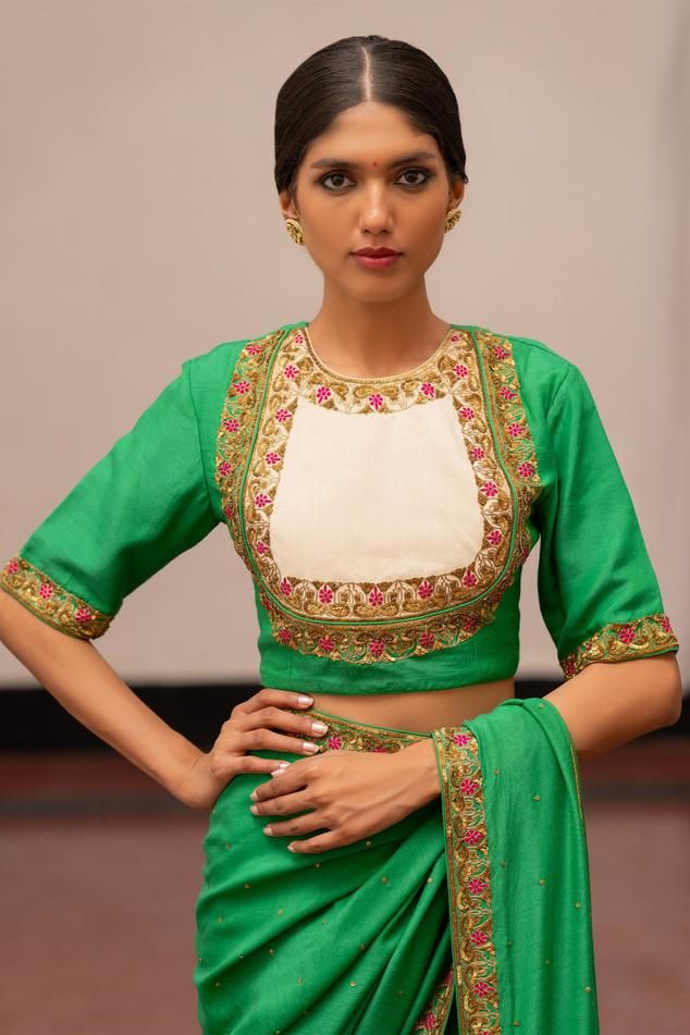 Emerald and ivory two tone blouse with floral embroidery
Components: 1
Pattern: Embroidery
Type Of Work: Floral
Neckline: Round Neck
Sleeve Type: Half Sleeves
Fabric: Munga Silk 
Color: Green
Other Details: 
Model height: 5ft 7inches, wearing size S
Length: 1.5m
Note: Saree worn by the model is not for sale
Occasion: Sangeet - Aza Fashions White Blouse For Eid Reception, Reception Blouse With Cutdana And Traditional Drape, Traditional Drape Blouse With Cutdana For Reception, Designer Floral Embroidered Top For Diwali, Traditional Drape Embroidered Top For Wedding, Embroidered Top With Resham Embroidery For Festive Reception, Festive Embroidered Top For Reception With Traditional Drape, Festive Embroidered Top For Reception, Designer Embroidered Top With Traditional Drape