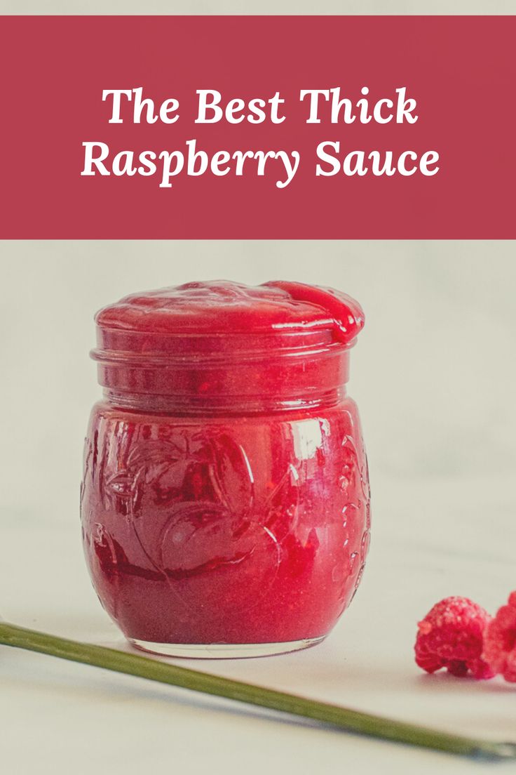 raspberry sauce in a jar next to fresh raspberries