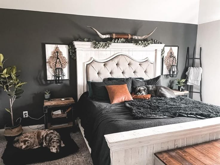 a bedroom decorated in black and white with antlers on the wall