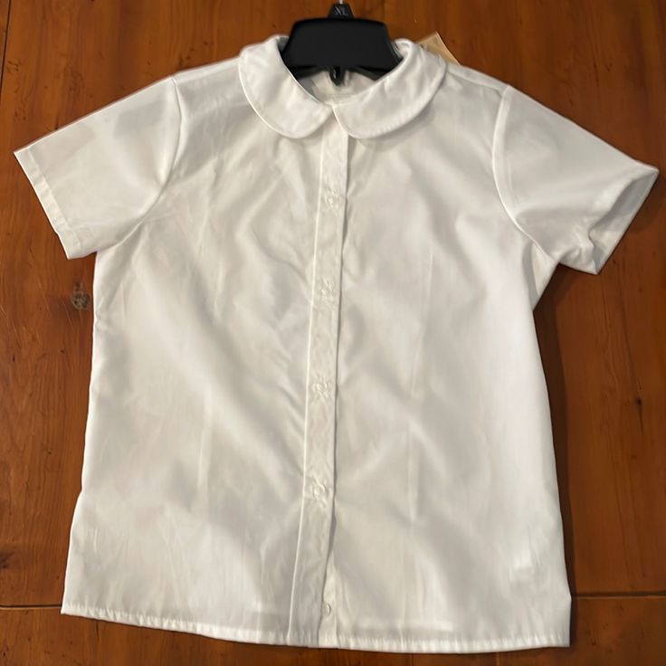 The Top Is New With Tags. I Great School Wear Top Made From Cotton And Polyester, And. Arm Pit To Armpit Is 16 Inches Wide. Collared T-shirt For School In Spring, Spring School T-shirt With Collar, Casual White Top With Peter Pan Collar, Collared Summer Tops For School, White Short Sleeve T-shirt With Buttons, White School Blouse For Spring, White Spring Blouse For School, White Blouse For School In Spring, Spring School Tops With Short Sleeves