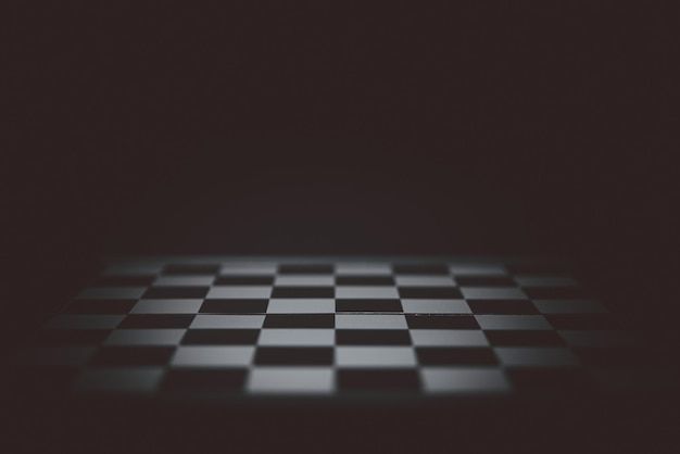 a black and white checkerboard pattern is shown in the dark, with light coming through