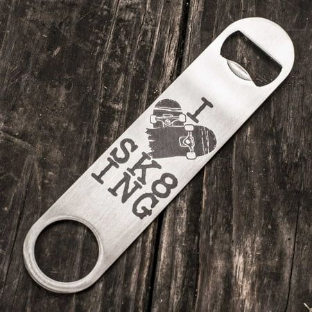 a bottle opener with the words i'm king on it sitting on top of a wooden table