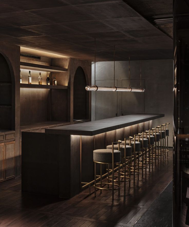 an empty bar with stools and barstools in a dimly lit restaurant area