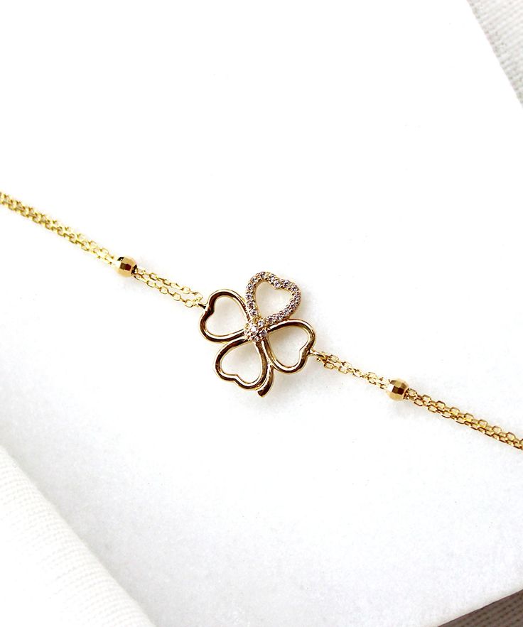 14K Gold Clover Bracelet This elegant bangle bracelet is 14K gold and showcases the symbol of luck, a four leaf clover. It has a unique design and is perfect for everyday wear as it is made of solid gold and won't tarnish. It is a wonderful gift for a special person or for yourself. Features: * This necklace is made of patented 14K solid gold. * It has a 18 cm chain. * Weight: 2,23 grams Packaging: You will get your jewelry in a beautiful pink Pharos Jewellery box. This box will protect your pre Elegant Good Luck Bracelet Jewelry, Elegant Good Luck Jewelry Bracelet, Bride Bracelet, Amulet Bracelet, Lucky Charm Bracelet, Protection Amulet, Wedding Bridal Jewellery, Elegant Bracelet, Minimalist Bracelet