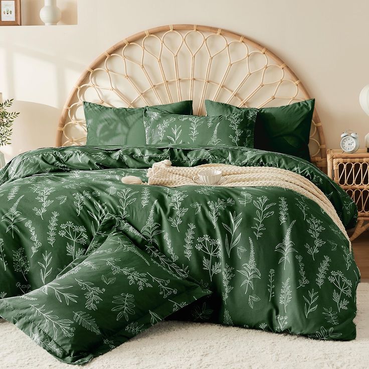 a bed with green comforters and pillows