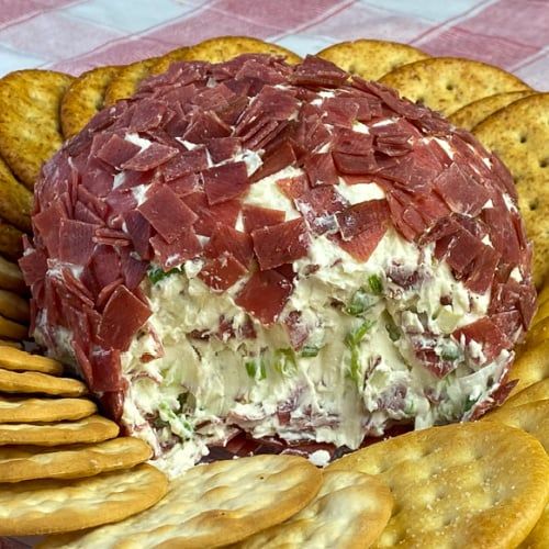 a cheese ball with crackers on the side