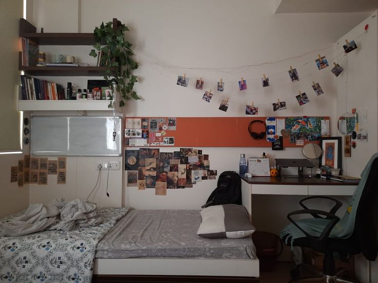 a bed room with a neatly made bed next to a desk and bookshelf