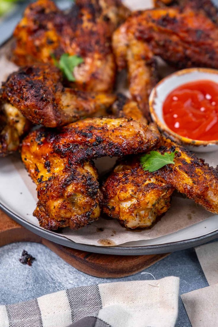 grilled chicken wings with ketchup on a plate