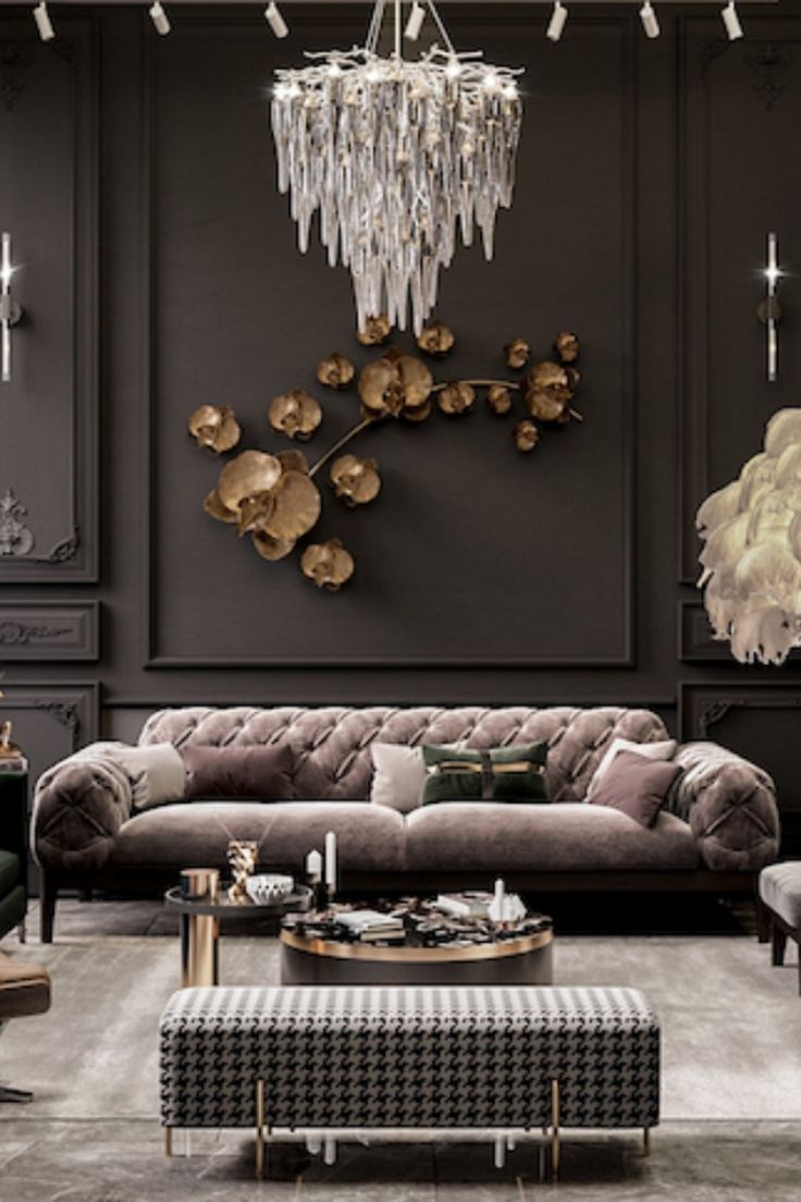 a living room filled with furniture and a chandelier hanging over the top of it