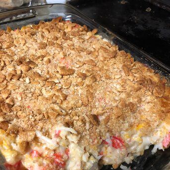 a casserole dish with toppings in a glass pan on top of a stove