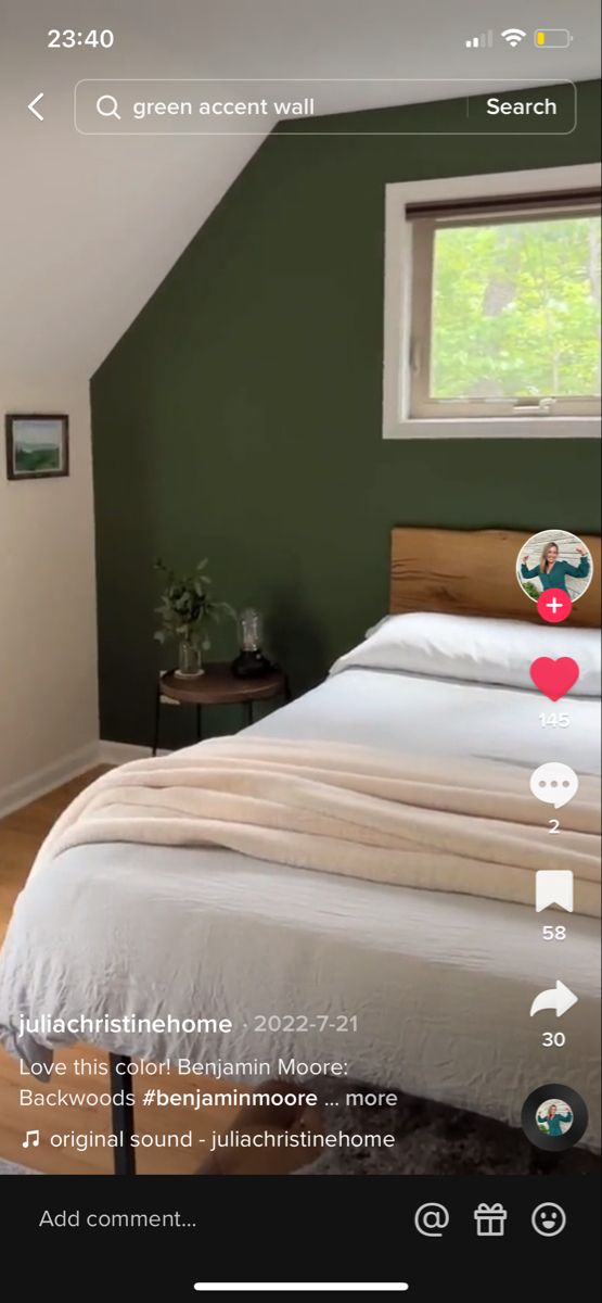 an image of a bedroom with green walls and white bedding in the foreground