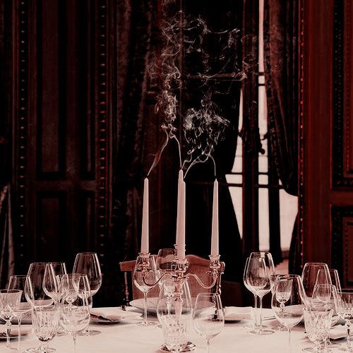 the table is set with wine glasses and candles for an elegant dinner or special event