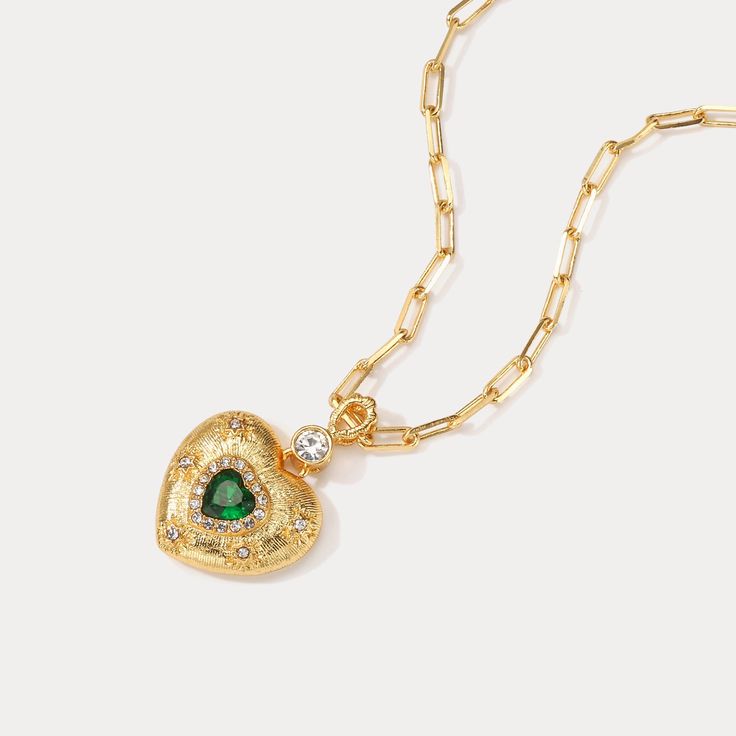 Look no further than this dazzling Emerald Mini Heart Necklace! This gorgeous piece is perfect if you're looking to add a little sparkle to your look. Show-stoppingly stunning, this necklace will make sure you look dazzling wherever you go! 💚 DETAILS Plating: 18K Gold Materials:   18K Gold on Brass, Glass, Gemstone Length:  16.93 "(43cm) + Extender: 3.15"(8cm) Pendant   Size :  1.22"*0.83"(3.1cm*2.1cm) Weight:  15.6 g Gold Heart Pendant Chain Necklace For Party, Heart Pendant Necklace With Charm For Party, Elegant Gold-plated Heart Charm Necklace, Party Necklace With Heart Pendant And Beads, Heart Charm Necklace For Party, Party Heart Pendant Necklace With Heart Charm, Party Necklaces With Heart Beads And Pendant, Heart Pendant Cubic Zirconia Necklace For Party, Heart-shaped Cubic Zirconia Necklaces For Party