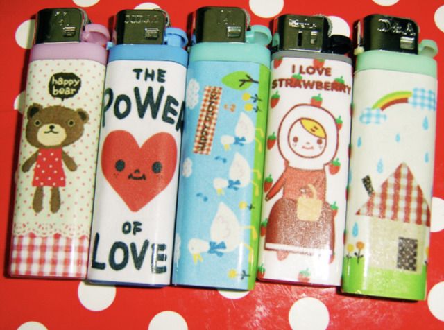 four lighters are lined up on a polka dot table