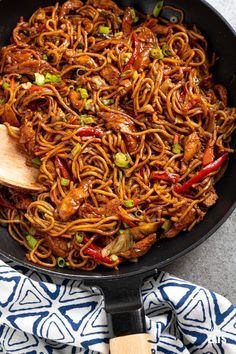 a skillet filled with noodles and meat