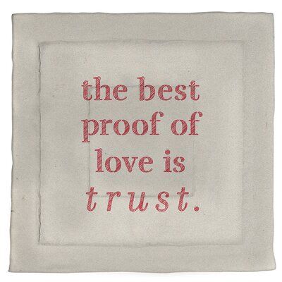 the best proof of love is trust embroidered on a white linen square with red thread