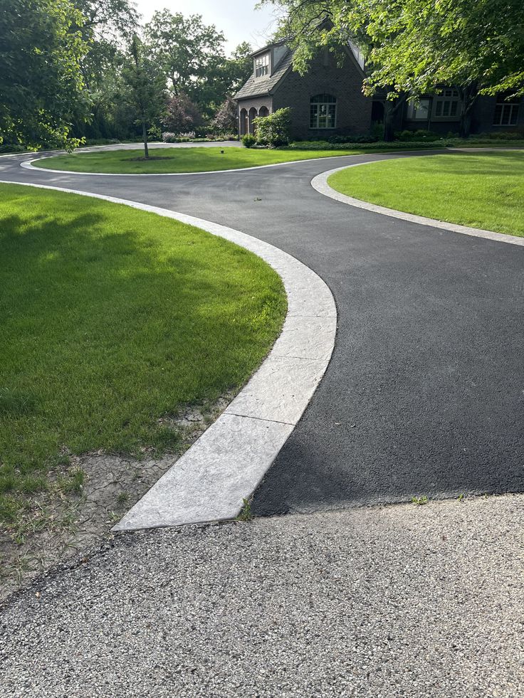 a curved driveway in front of a house