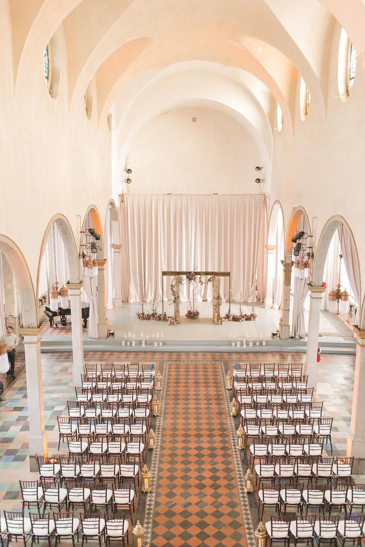 an indoor wedding venue with rows of chairs