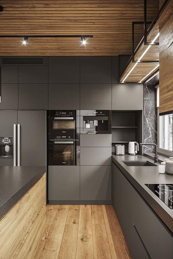 a modern kitchen with wood floors and gray cabinets, along with an island countertop