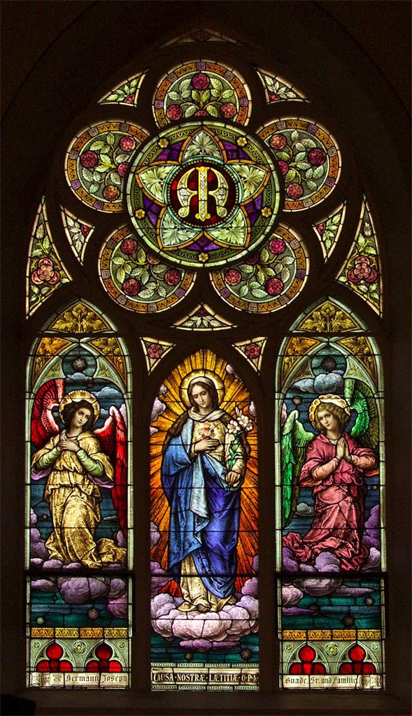 a stained glass window with the image of jesus and mary