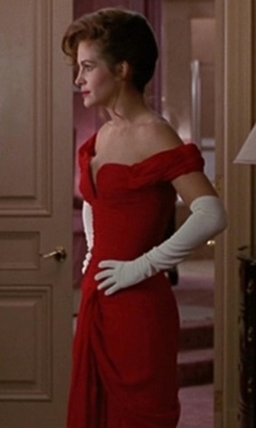 a woman in a red dress and white gloves