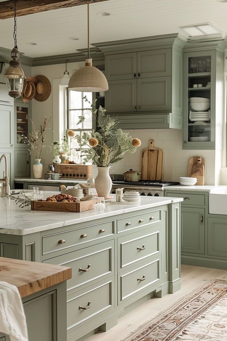 a kitchen filled with lots of green cupboards and counter top space next to a sink