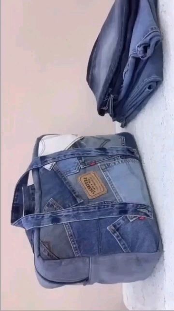 an old pair of jeans is sitting on the floor next to a purse and jacket