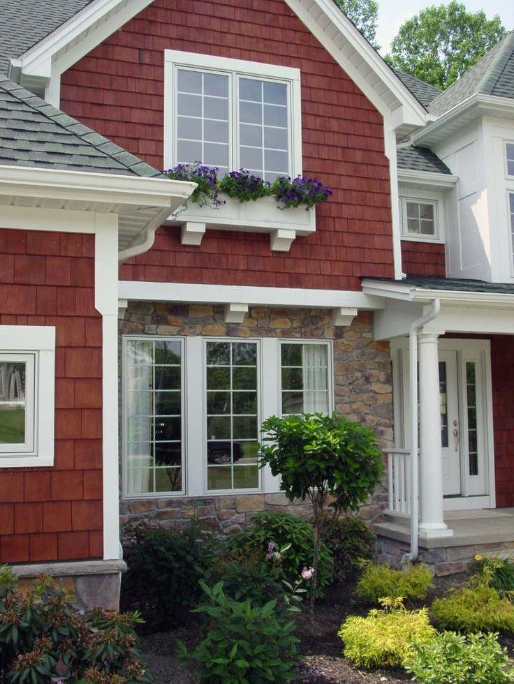 a red house with white trim and windows