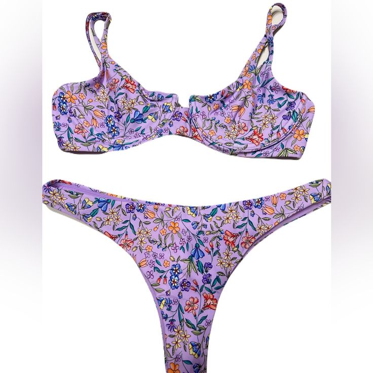 B Swim Aruba Top In Beachfront Bloom Print. Size Medium. Stock Photo To Show Style And Color And Fit. Last Few Personal Gallery Pics Are Of Actually Swim Suit. This Bombshell Bra Will Flatter Any Shape And Provide Just The Right Amount Of Support. Adjustable Straps And Underwire Make The Aruba Top Just As Comfortable As It Is Cute And Classy. Underwire Adjustable Straps Hook Closure At Back Bottom Is The Havana Bottom. Also Medium. Color Is Beachfront Bloom. Pics To Show Style And Fit. The Havan Purple Swimwear For Sunbathing During Beach Season, Purple Tropical Swimwear For Poolside, Purple Swimwear For The Beach, Tropical Purple Swimwear For Pool, Purple Triangle Top Swimwear For Poolside, Purple Triangle Top Swimwear For Beachwear, Purple Floral Print Swimwear For Beach, Purple Floral Print Swimwear For Vacation, Purple Beachwear Swimwear For Poolside