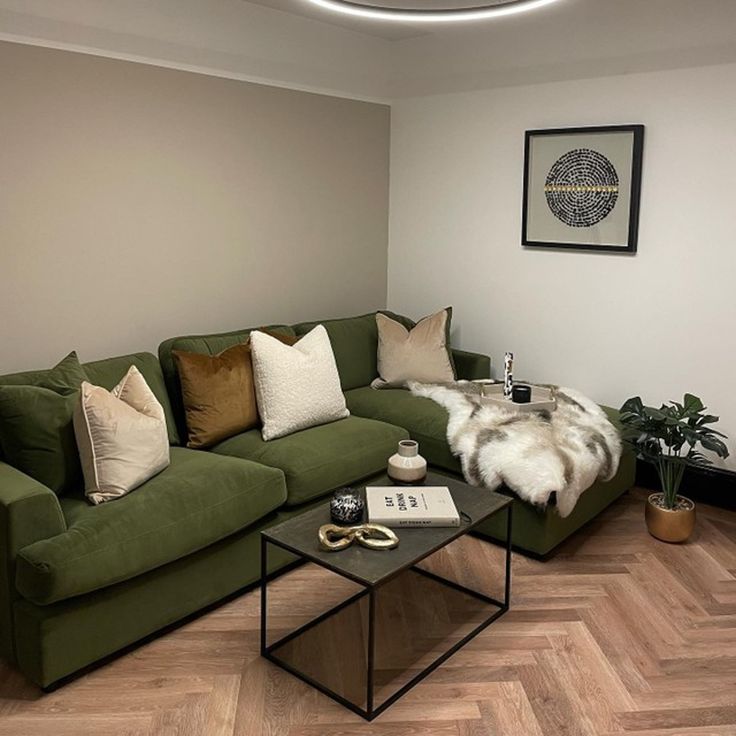 a living room with a green couch and coffee table