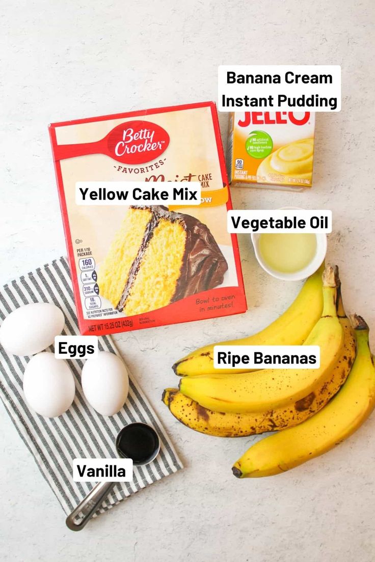 bananas, eggs, and cake mix on a white counter top with labels describing the ingredients