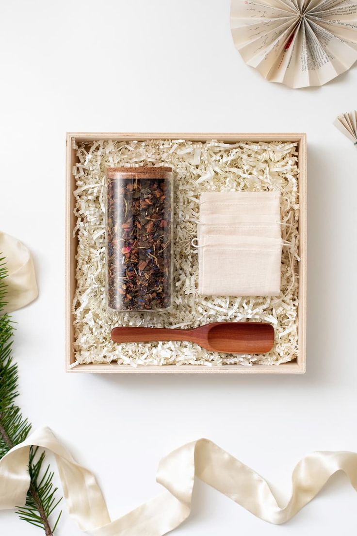 an open box with spices and napkins on top of it next to christmas decorations