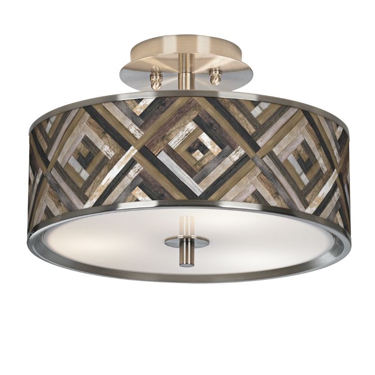 a semi flush light fixture with an art deco pattern on the drum and chrome finish