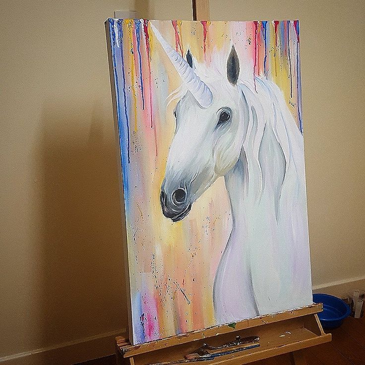 a painting of a white horse on an easel