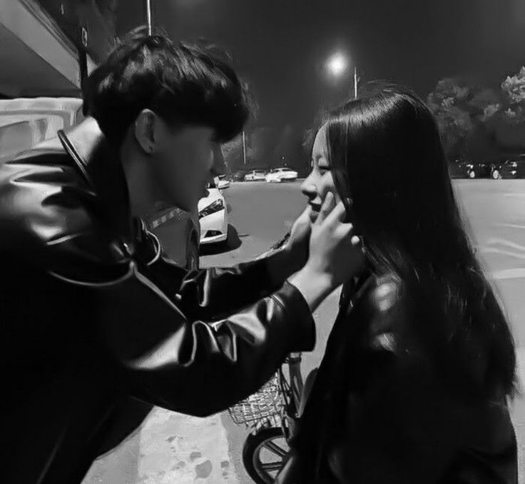 a man is helping a woman put on her hair while she sits on a bike