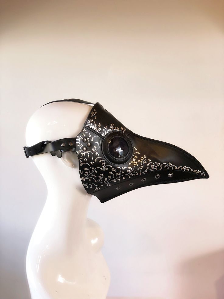 Pictures are back plague masks with white pearl filigree shades. Other filigree colors also available. Pls leave a checkout note with your color requests to match your outfit.  This Jackdaw bird mask plague doctor cosplay masquerade mask is made with faux leather and metal rivets. Adjustable buckle in back. Lightweight and comfortable to wear. Shaded plastic lens for viewing. Holes under the beak for easy breathing. S H I P P I N G  -   We strive to process same day or within 24 hours  1-2 day guaranteed delivery services offered, add items to cart and click on shipping tab for rates. We have stock materials to make your product and the USPS and FEDEX services are operational. We've made arrangements with our local post office for mail drop without any human interaction for added safety. P Jackdaw Bird, Plague Masks, Plague Doctor Hat, Plague Doctor Halloween Costume, Halloween Masquerade Ball, Plague Doctor Cosplay, Steampunk Plague Doctor, Elegant Face Mask, Doctor Halloween